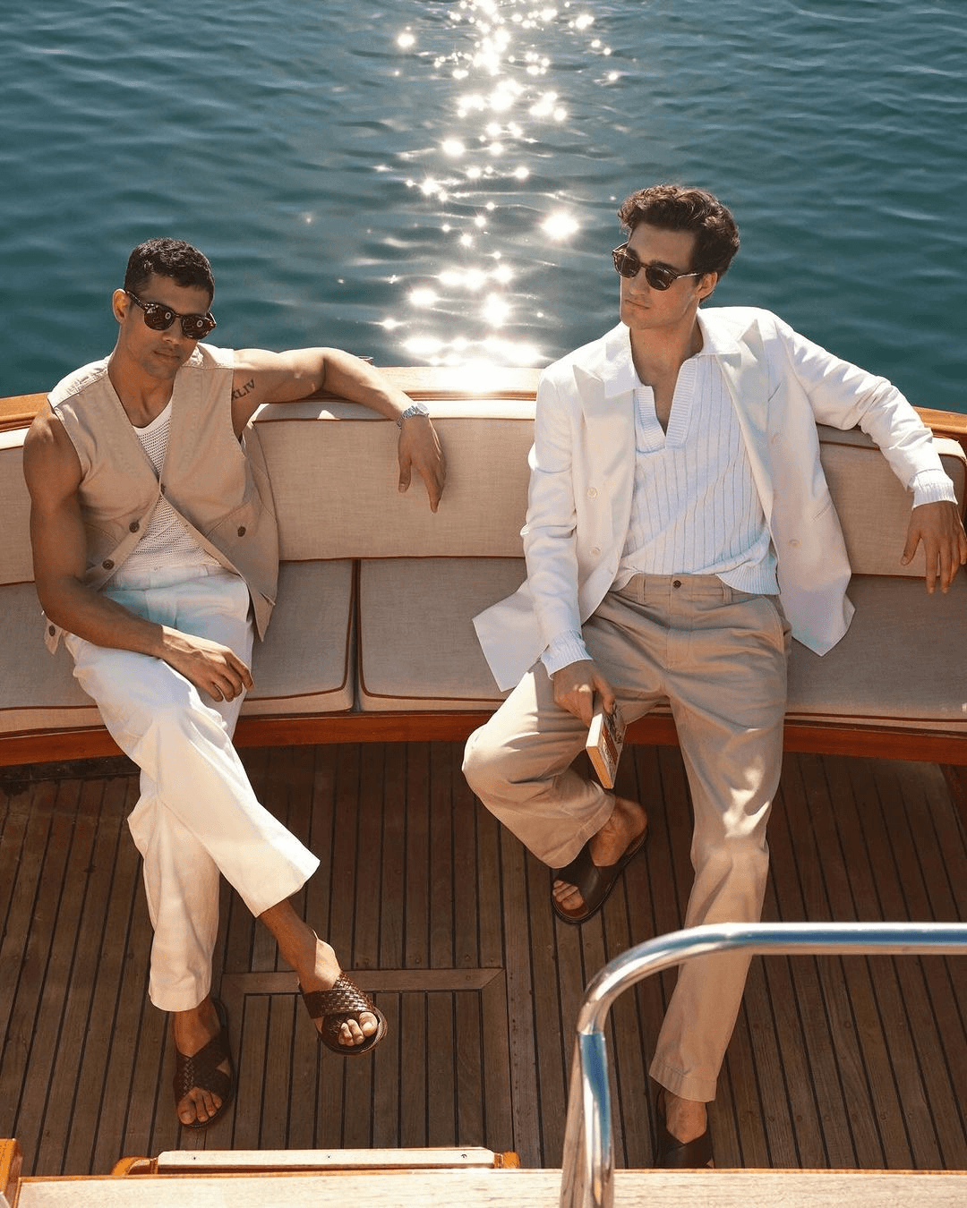 Two people seated on a boat in bright afternoon light.